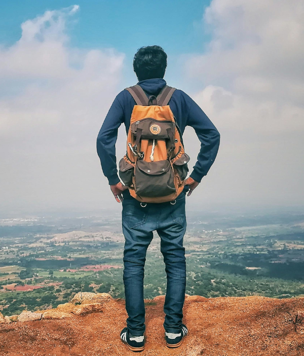 man overlooking from a cliff